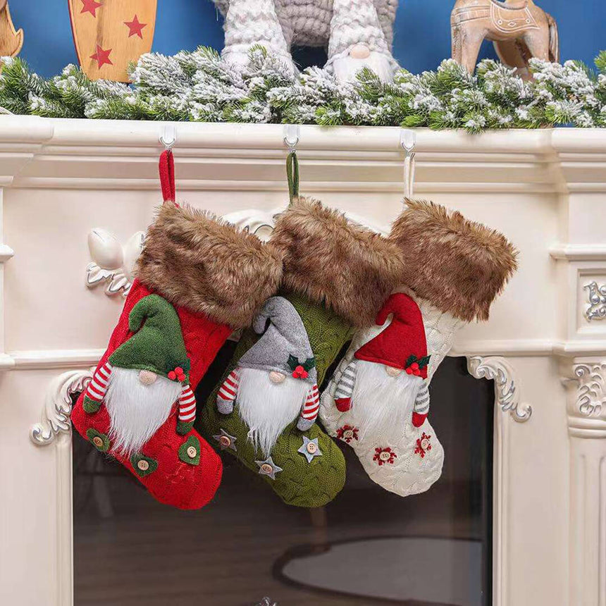 Three gnome-themed Christmas stockings hanging on a fireplace