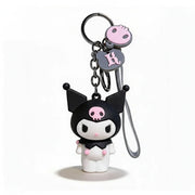 Cartoon character keychain with black hair and pink accents on a white background