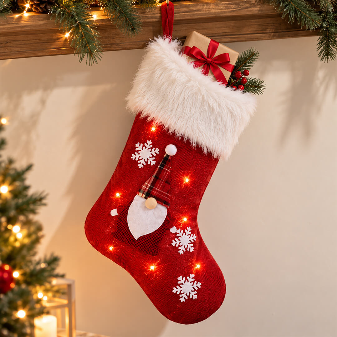 Red LED Christmas stocking hanging with small gifts inside