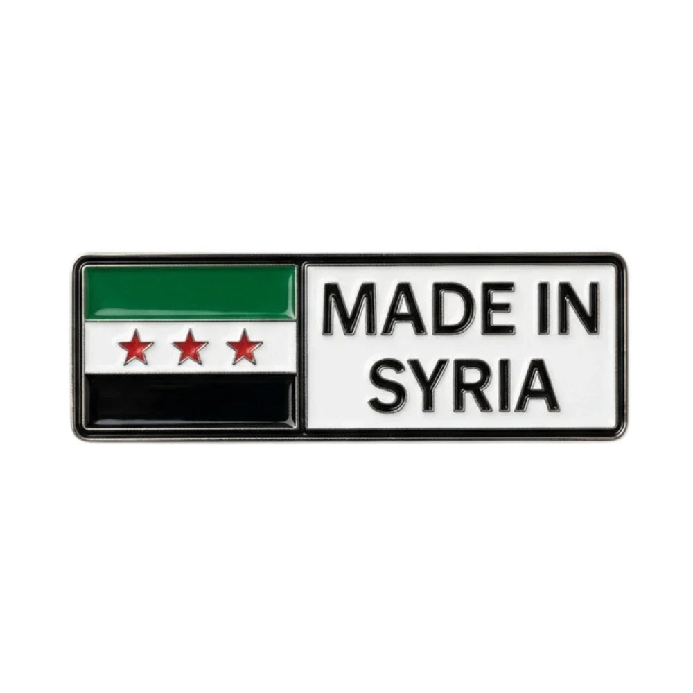 Flag of Syria with 'Made in Syria' text enamel phone sticker on a white background