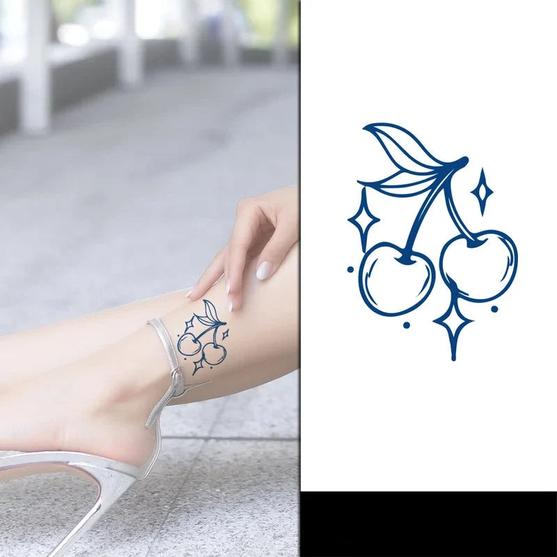 small cherries tattoo on females leg
