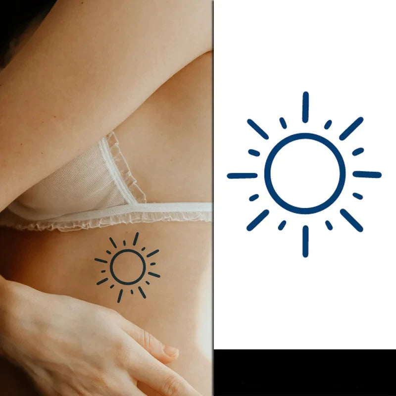 small minimalistic sun tattoo under a womans breast