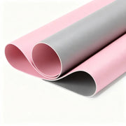 Two rolls of pink and gray vinyl on a white background