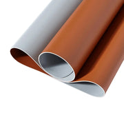 Two rolls of vinyl wrap, one gray and one brown, on a white background.