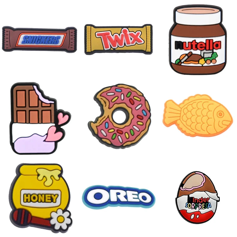 Collection of colorful candy and snack-themed croc pins on a white background