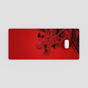 Red mouse pad with black dragon design on a light gray background