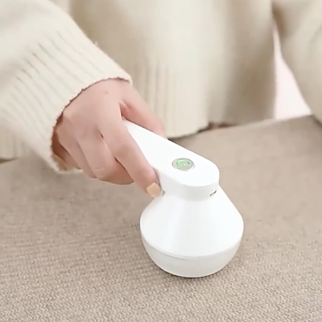 White portable lint remover with USB cable for sweater