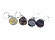 Four keychains with different designs on a white background