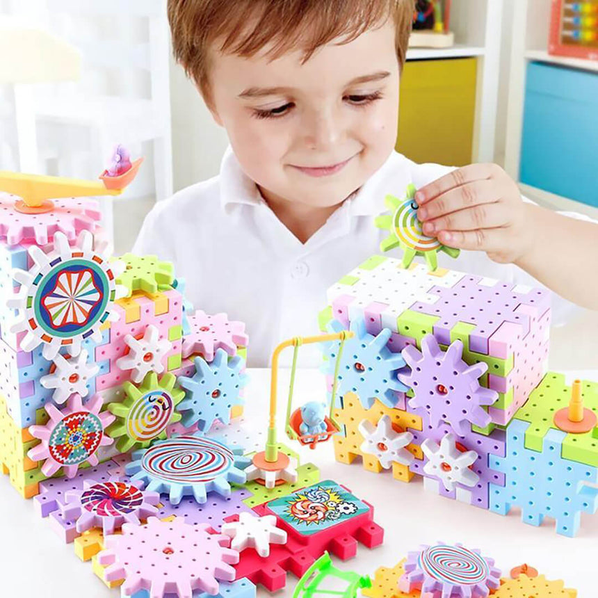 Child playing with colorful gear and magnetic blocks