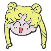 A cartoon enamel pin of a cheerful anime girl with yellow hair, twin buns, and a pink face, outlined in black on a white background.