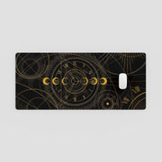 Phone case with gold astrological design on a black background