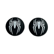 Black earrings with white spider design on a white background