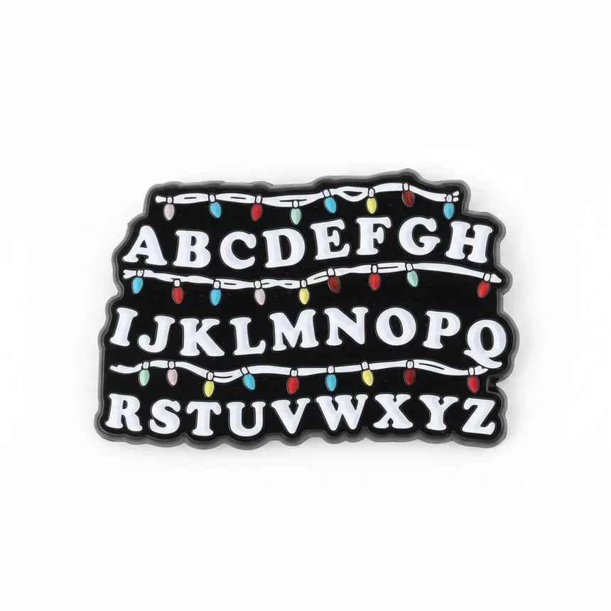 Black sign with white letters and Christmas lights design on a white background