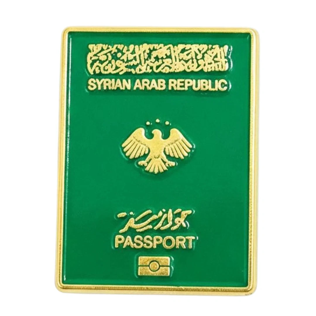 A green and gold replica enamel phone sticker designed to look like a Syrian Arab Republic passport, shown on a plain white background.