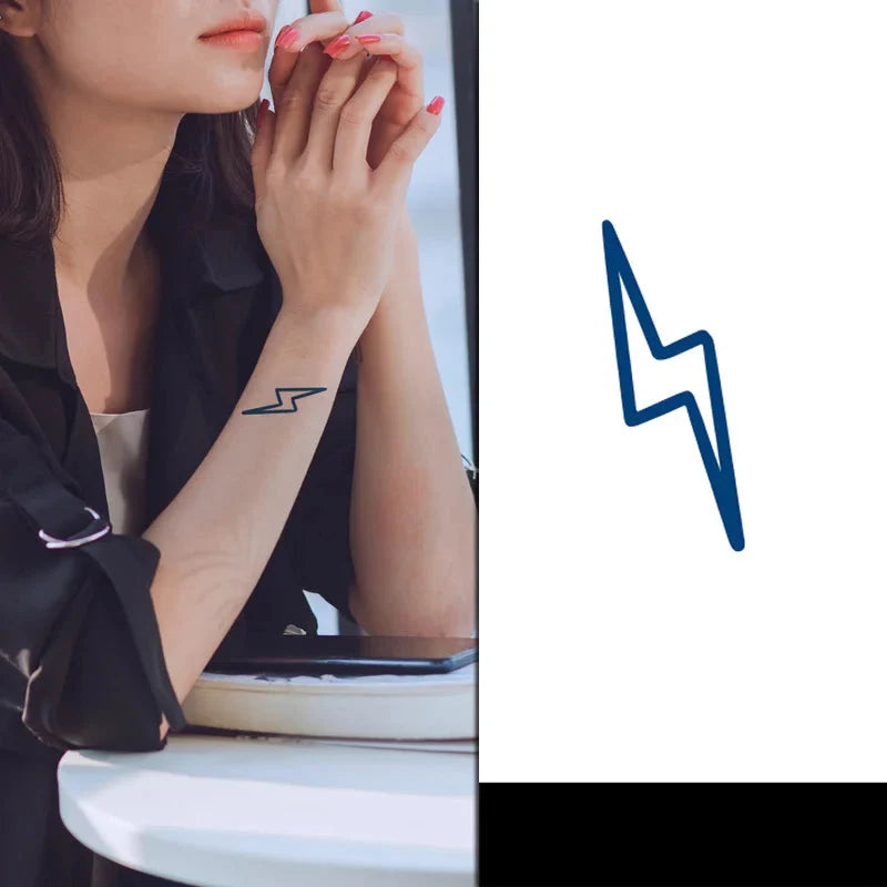 Woman with a lightning bolt tattoo on her arm, sitting on a white chair with a blue lightning bolt graphic 