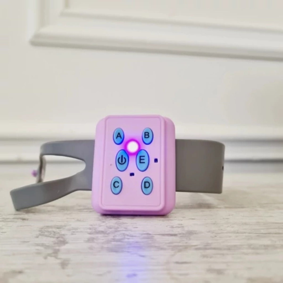 Pink gravity sensor wristband remote close-up