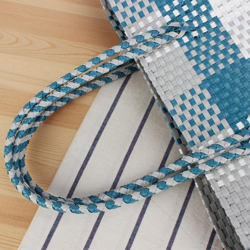 Large straw shoulder tote with waterproof interior