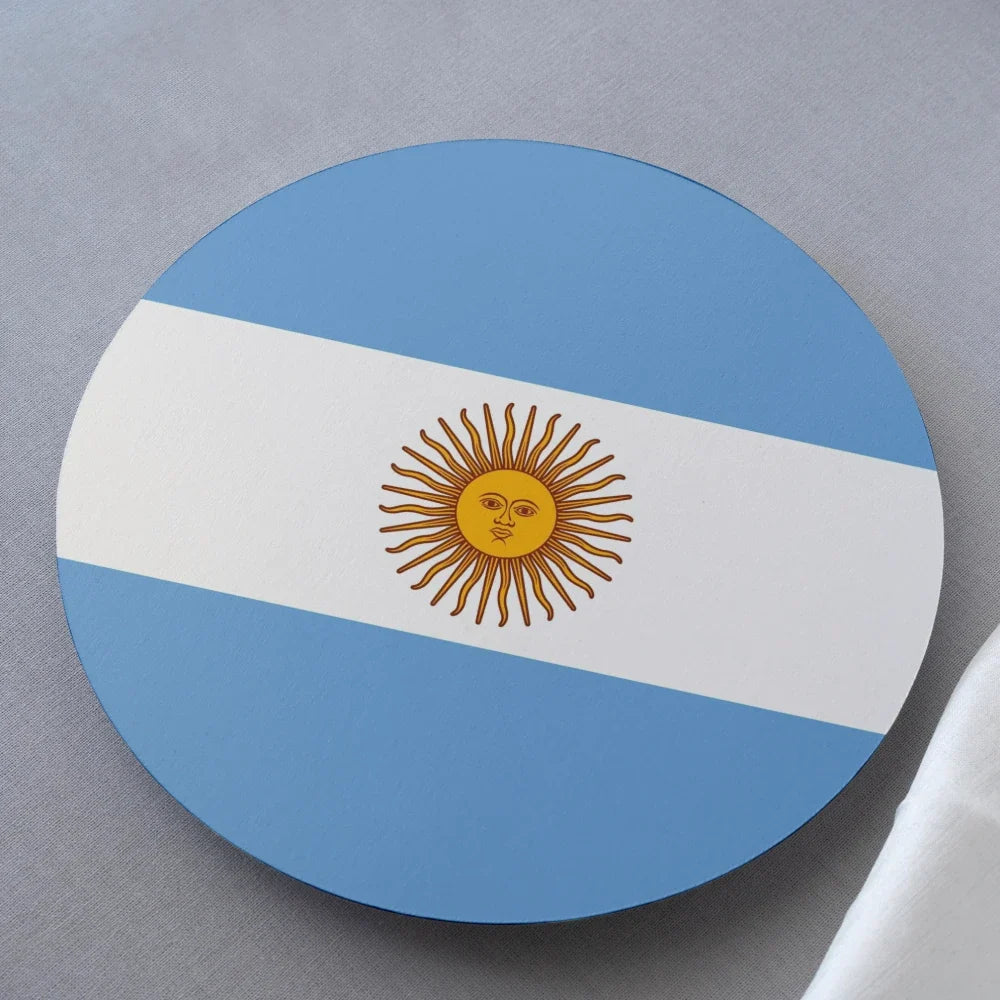 Round coaster with the Argentine flag design on a gray surface