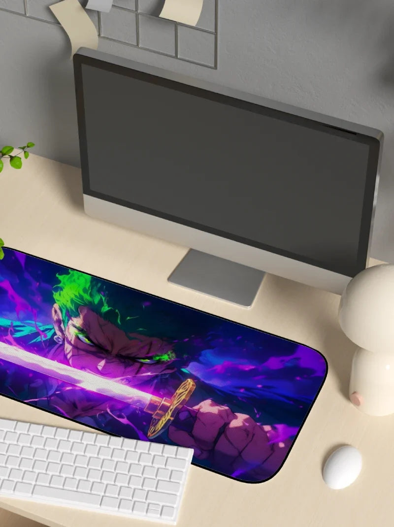 Desk setup with a computer monitor, keyboard, and mouse on a large mouse pad featuring an anime character.